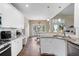 Bright kitchen features granite countertops, stainless steel appliances, and white cabinetry at 7010 Beloit Pl, Roswell, GA 30075