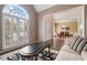 Comfortable living room with large arched windows, stylish furniture, and hardwood floors at 7010 Beloit Pl, Roswell, GA 30075