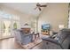 Bright living room featuring a fireplace, hardwood floors, and large windows at 7010 Beloit Pl, Roswell, GA 30075