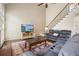Comfortable living room with high ceilings, a ceiling fan and a staircase at 7010 Beloit Pl, Roswell, GA 30075