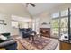 Spacious living room with cathedral ceilings, fireplace, and access to outdoor space at 7010 Beloit Pl, Roswell, GA 30075