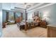 The main bedroom features a tray ceiling and a four poster bed with matching dresser at 7010 Beloit Pl, Roswell, GA 30075