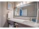 Bright bathroom featuring a modern vanity with a large mirror and a decorative wall hanging at 111 John Christopher Dr, Alpharetta, GA 30009