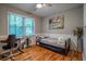 Comfortable bedroom featuring a daybed, desk, chair, and natural light from the window at 111 John Christopher Dr, Alpharetta, GA 30009