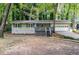 Charming ranch home with a covered porch, blue shutters, manicured yard, and a two-car garage at 111 John Christopher Dr, Alpharetta, GA 30009