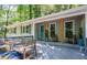 Charming front porch with inviting seating area, colorful blue door, and craftsman style pillars at 111 John Christopher Dr, Alpharetta, GA 30009