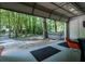 Entertaining space with open garage door leading to lush wooded backyard at 111 John Christopher Dr, Alpharetta, GA 30009