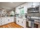 Bright kitchen with white cabinets, modern appliances, and hardwood floors at 111 John Christopher Dr, Alpharetta, GA 30009