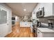 Spacious kitchen with stainless appliances and adjoining shelving at 111 John Christopher Dr, Alpharetta, GA 30009