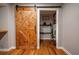 Entryway with barn door leading to the laundry room at 111 John Christopher Dr, Alpharetta, GA 30009