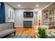 Inviting living room with hardwood floors, comfortable seating, and a built-in bookshelf at 111 John Christopher Dr, Alpharetta, GA 30009