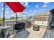 Spacious outdoor deck area with comfortable seating, BBQ grill, fire pit, and umbrella at 243 Retreat Ln, Canton, GA 30114