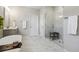 Bright bathroom features a soaking tub, glass shower, and marble-look floors at 243 Retreat Ln, Canton, GA 30114
