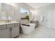 Bright bathroom features a soaking tub, double vanities, and marble-look floors at 243 Retreat Ln, Canton, GA 30114