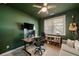 A cozy bedroom features a modern desk setup, guitar, and a comfortable sofa at 243 Retreat Ln, Canton, GA 30114