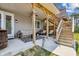 Spacious covered patio with a seating area, stairs to an upper deck, and an outdoor bar at 243 Retreat Ln, Canton, GA 30114
