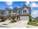 Charming townhome with beautiful gray siding, brick accents, and a two-car garage in a lovely neighborhood at 243 Retreat Ln, Canton, GA 30114