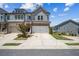 Beautiful townhome showcasing a two-car garage, well-manicured lawn, and brick accents at 243 Retreat Ln, Canton, GA 30114