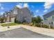 Charming townhome with a two-car garage, landscaped front yard, and gray siding at 243 Retreat Ln, Canton, GA 30114