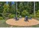 Inviting community firepit area surrounded by Adirondack chairs and lush greenery at 243 Retreat Ln, Canton, GA 30114