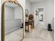 Well-lit upstairs hallway with decorative mirror, table and carpeted floors at 243 Retreat Ln, Canton, GA 30114