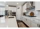 Modern kitchen featuring white cabinets, stainless steel appliances, and a stylish backsplash at 243 Retreat Ln, Canton, GA 30114