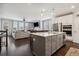Open concept kitchen with island seating, stainless appliances, flows into the living area with fireplace at 243 Retreat Ln, Canton, GA 30114