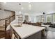 Spacious kitchen island open to the living room with stainless steel sink and wood flooring at 243 Retreat Ln, Canton, GA 30114