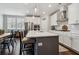 Bright, spacious kitchen featuring white cabinets, a large island, stainless steel appliances, and hardwood floors at 243 Retreat Ln, Canton, GA 30114