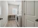 Functional laundry room features a window, built-in shelves, and a washer and dryer at 243 Retreat Ln, Canton, GA 30114