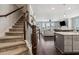 Open-concept living area connects the stairs, kitchen, and living room for easy living at 243 Retreat Ln, Canton, GA 30114