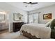 Bright main bedroom with a large bed, dark dresser, ensuite bath, and natural light at 243 Retreat Ln, Canton, GA 30114
