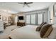 Spacious main bedroom featuring a ceiling fan, large windows, and lots of natural light at 243 Retreat Ln, Canton, GA 30114