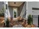 Charming covered back porch with brick accents, providing a cozy outdoor seating area with privacy fencing at 2467 Davis Se Dr, Smyrna, GA 30080