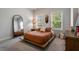 Stylish bedroom with a minimalist platform bed, large mirror, and natural light, creating a tranquil atmosphere at 2467 Davis Se Dr, Smyrna, GA 30080