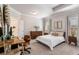 Inviting bedroom with a tray ceiling, neutral decor, and a workspace at 2467 Davis Se Dr, Smyrna, GA 30080