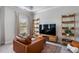 Cozy bedroom with a comfortable chair, stylish shelves, and a large television at 2467 Davis Se Dr, Smyrna, GA 30080