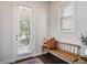 Bright entryway with a wooden bench, pillows, and a view of the outdoors at 2467 Davis Se Dr, Smyrna, GA 30080