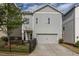 Two-story home with gray siding, a two-car garage, a fenced yard, and a well-maintained lawn at 2467 Davis Se Dr, Smyrna, GA 30080