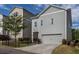 Exterior view of two-story home with gray siding, garage, a fenced yard and driveway at 2467 Davis Se Dr, Smyrna, GA 30080