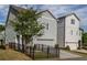 Gray home exterior featuring a driveway, garage, front yard, and fenced area at 2467 Davis Se Dr, Smyrna, GA 30080