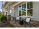 Inviting front porch with gray siding, brick accents, and comfortable outdoor seating at 2467 Davis Se Dr, Smyrna, GA 30080