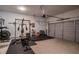 Spacious garage with a home gym setup and ample storage space, featuring an automatic garage door at 2467 Davis Se Dr, Smyrna, GA 30080