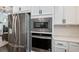 This kitchen features stainless steel appliances, white countertops, and sleek white cabinets at 2467 Davis Se Dr, Smyrna, GA 30080