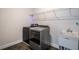 Modern laundry room with washer, dryer, utility sink, and wire shelving at 2467 Davis Se Dr, Smyrna, GA 30080