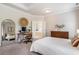 Spacious main bedroom featuring an adjacent office space, a stylish dresser, and a large mirror at 2467 Davis Se Dr, Smyrna, GA 30080