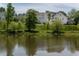Picturesque view of a pond reflecting the surrounding homes and greenery in a peaceful community at 2467 Davis Se Dr, Smyrna, GA 30080