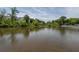 Scenic view of a tranquil pond surrounded by lush greenery and charming homes in the background at 2467 Davis Se Dr, Smyrna, GA 30080