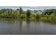 Picturesque view of a pond reflecting surrounding houses and lush greenery at 2467 Davis Se Dr, Smyrna, GA 30080