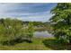 Scenic view of a pond with houses nestled among trees and lush greenery at 2467 Davis Se Dr, Smyrna, GA 30080